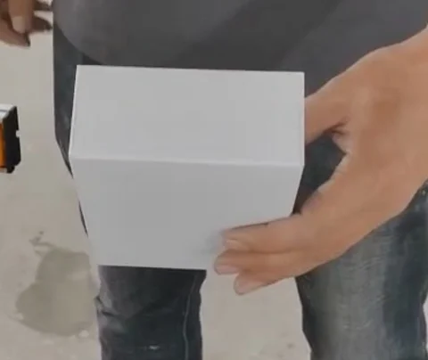 Actual formed empty carton held by the CK-E020-1 demo operator